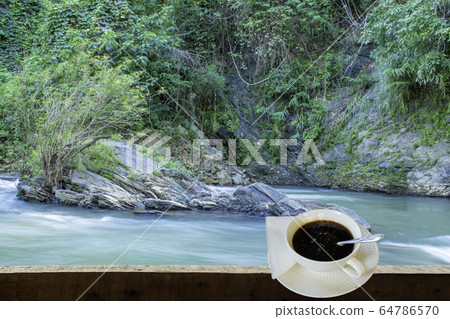 Isolated Hot coffee Put a glass of white with a casual break from work background waterfall Isolated Hot coffee Put a glass of white with a casual break from work background waterfall 64786570