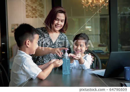 asian family hand gel wash while quarantine at home 64790809