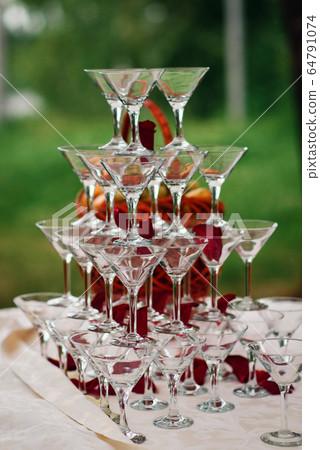 pyramid of glasses for Martini and champagne for a festive reception pyramid of glasses for Martini and champagne for a festive reception 64791074