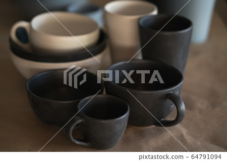 Matt ceramic handmade tableware in a workshop closeup 64791094