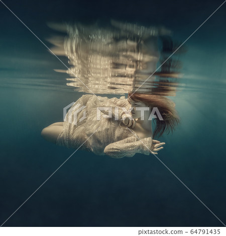 Girl in a sequined dress swims underwater Girl in a sequined dress swims underwater 64791435
