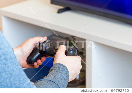 Woman hands with a game controller, relaxation Woman hands with a game controller, relaxation 64792750