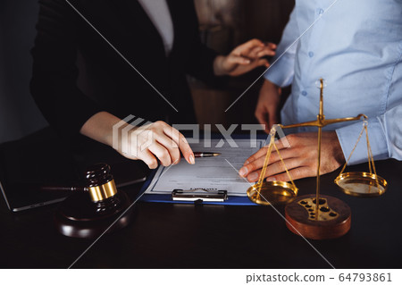 Business - meeting in an office, lawyers or attorneys discussing a document or contract agreement 64793861
