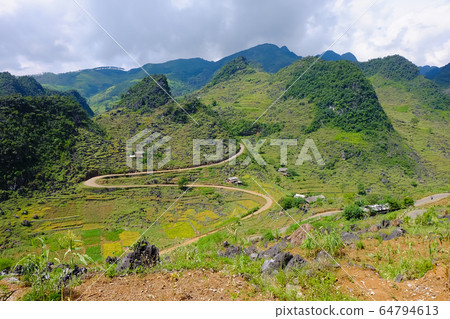 The beautiful landscape scenery of Dong Van rock plateau with mountains, rocks, and trees, located at the most northern point in Ha Giang the most popular destination in this region Vietnam. The beautiful landscape scenery of Dong Van rock plateau with mountains, rocks, and trees, located at the most northern point in Ha Giang the most popular destination in this region Vietnam. 64794613