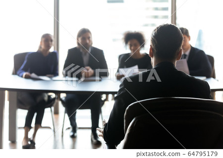 Rear view candidate waiting for hr managers decision on interview 64795179