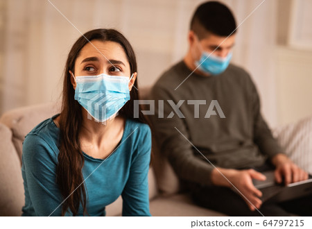 Man using laptop not paying attention to wife 64797215