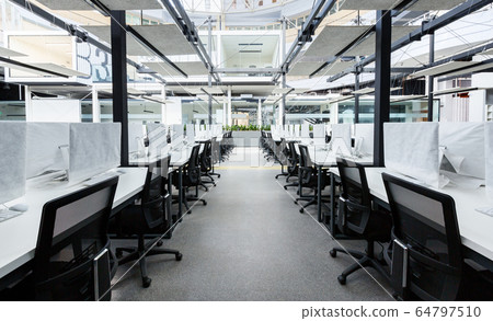 Co-working space with modern computers hiding by covers 64797510