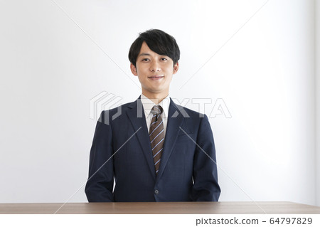 A young man in a suit 64797829