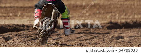 Racer child on motorcycle participates in motocross race, active extreme sport 64799038
