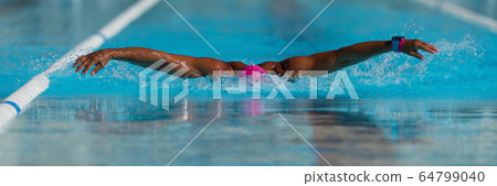 Swim competition swimmer athlete doing butterfly stroke in swimming pool Swim competition swimmer athlete doing butterfly stroke in swimming pool 64799040