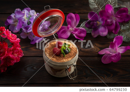 creamy dessert in a jar decorated with chocolate chips and berries creamy dessert in a jar decorated with chocolate chips and berries 64799230