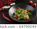 salad with tomatoes and leafy greens on a dark wooden background 64799249