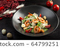 caesar salad with shrimp on a dark wooden background 64799251