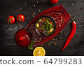 vegetable stew with potatoes and meat in a pot on a dark wooden background 64799283