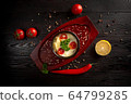 mashed potatoes in a pot decorated with tomatoes and parsley 64799285