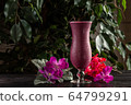 Cocktail with fruits and berries in a tall glass on a dark background 64799291