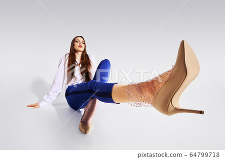 Cute girl in tulle socks on gray background Cute girl in tulle socks on gray background 64799718