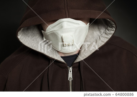 Aggressive man in medical face mask hiding 64800886