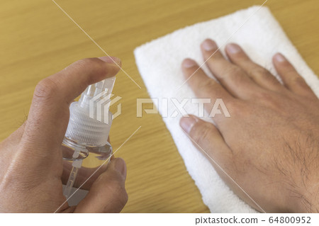Image of disinfecting with alcohol spray and towel Image of disinfecting with alcohol spray and towel 64800952