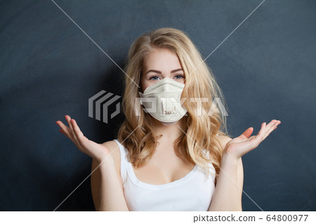 Happy woman in safety medical face mask  64800977