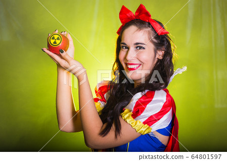Danger, nuclear and radiation measurement - Girl holds apple with radiation hazard symbol. 64801597