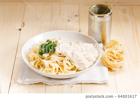 Italian pasta fettuccine with canned white creamy 64801617