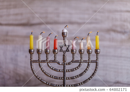 Extinguished Hanukkah candles and smoke. Stack of 64802171