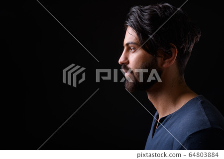 Profile view of handsome bearded Persian man 64803884
