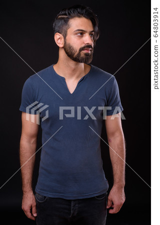 Portrait of handsome bearded Persian man thinking 64803914
