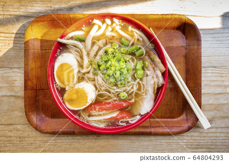 Tonkotsu ramen close-up, shot above, with eggs, scallions and mushrooams, with chopsticks on a tray 64804293