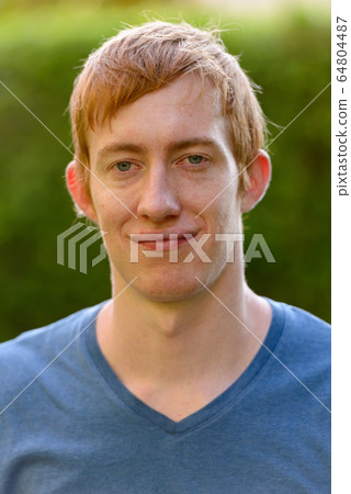 Face of man with red hair relaxing in the park Face of man with red hair relaxing in the park 64804487