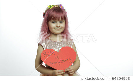 Child girl princess holds red paper heart with text about mother. Mother's day Child girl princess holds red paper heart with text about mother. Mother's day 64804998