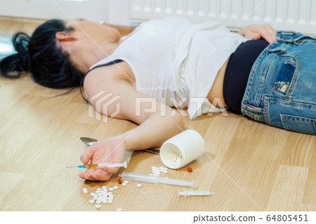 Drug addicted woman with a syringe sleeping overdose concept Drug addicted woman with a syringe sleeping overdose concept 64805451