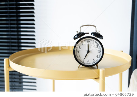 Stylish alarm clock with a bell. The hands show 7 Stylish alarm clock with a bell. The hands show 7 64805729