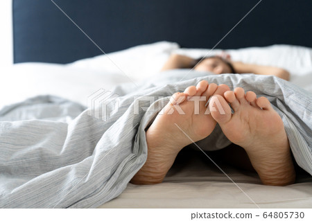 Feet of a sleeping girl in bed in the morning. Spy Feet of a sleeping girl in bed in the morning. Spy 64805730