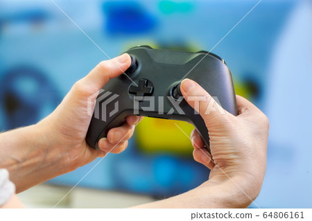 Hands holding console controller.Playing video games concept 64806161