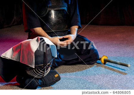 cropped calm kendo fighter sit on the floor 64806805