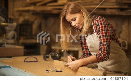 beautiful caucasian woman carpenter deals with handicraft 64807194
