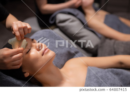 women get face massage. spa skin and body care women get face massage. spa skin and body care 64807415