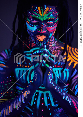 black man with fluorescent bodyart. studio shot black man with fluorescent bodyart. studio shot 64807652