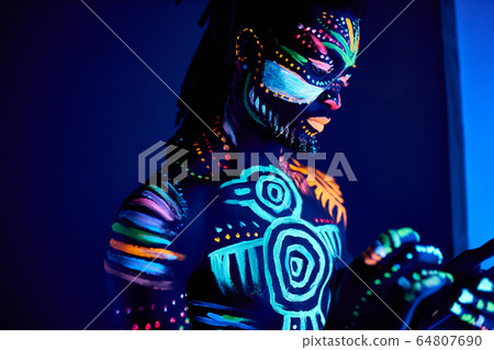 side view on african guy covered with fluorescent prints side view on african guy covered with fluorescent prints 64807690