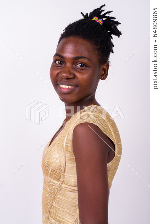 Profile view of happy young beautiful African woman looking at camera 64809865