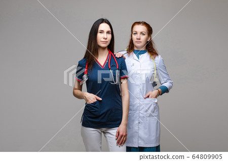 Two professional doctors with stethoscopes Two professional doctors with stethoscopes 64809905