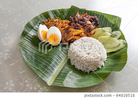 Basic authentic simple nasi lemak on banana leaf 64810518