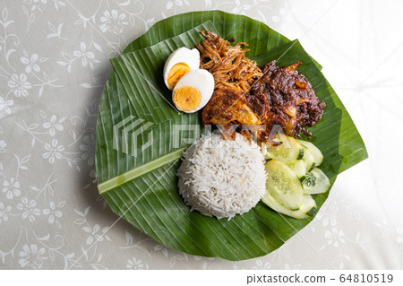Basic authentic simple nasi lemak on banana leaf 64810519