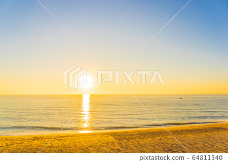 Beautiful tropical beach sea ocean with sunset or sunrise for travel vacation 64811540