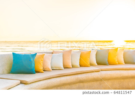 Comfortable pillow on sofa chair around outdoor patio with sea ocean beach view Comfortable pillow on sofa chair around outdoor patio with sea ocean beach view 64811547