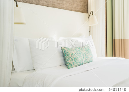 White comfortable pillow on bed decoration interior 64811548