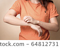 Women scratch itchy arm with hand. 64812731