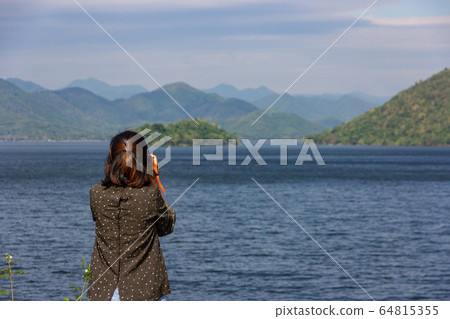 Asian woman tourist take a photo landscape of 64815355